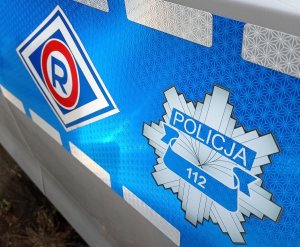 ilustracja z logo Policji i numerem alarmowym