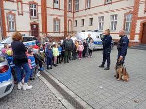 dzieci słuchają policjantów w trakcie spotkania w komendzie